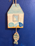 “Conchiglie” door tile with fish pendant